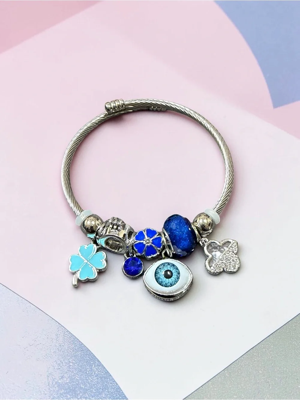 Silver Charm Twisted Bangle with Blue Eye and Blue Floral Charms